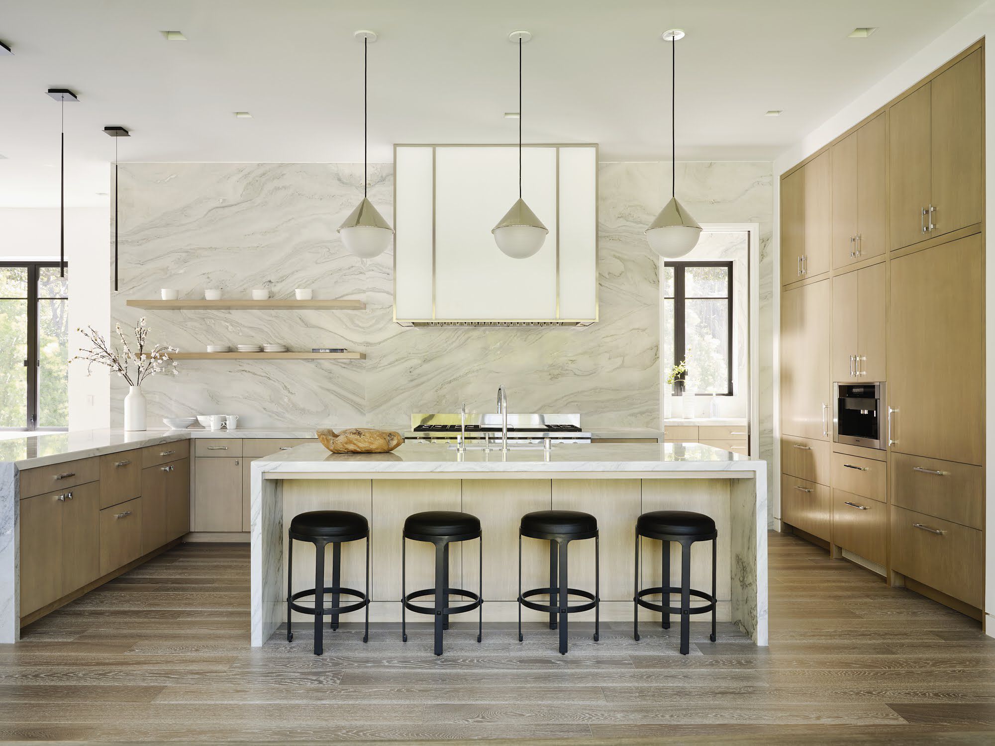 Home remodeling in Fort Myers — kitchen remodel with marble backsplash, oak cabinetry and waterfall island