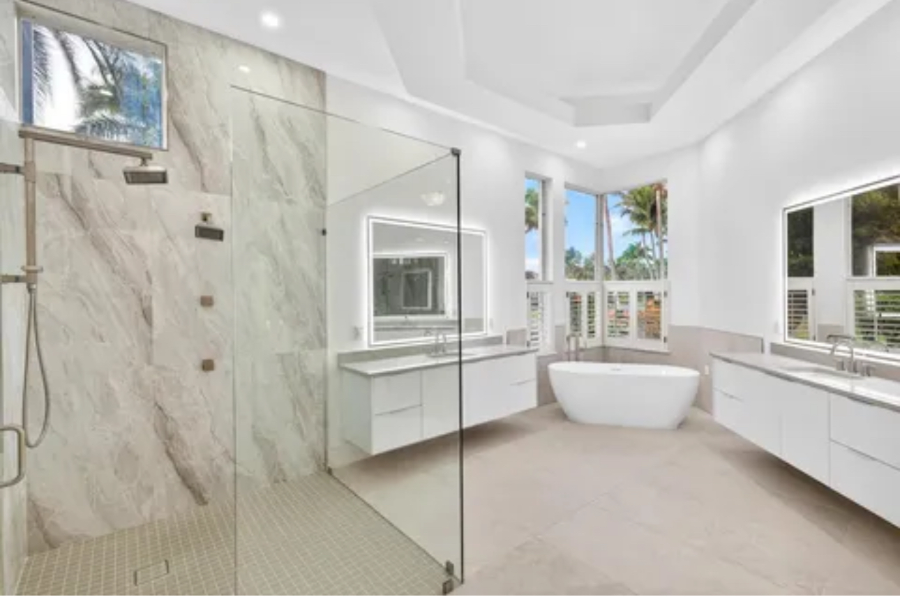 Luxury master bathroom transformation with frameless glass shower, freestanding tub and tray ceiling
